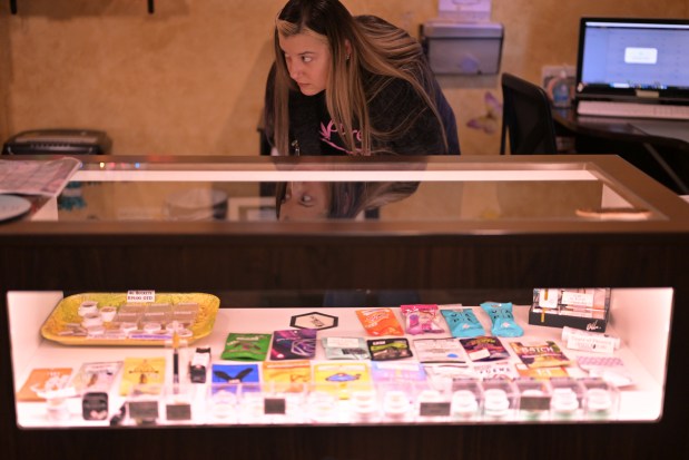 Lisa Breeden sorts medical marijuana products at Pure, a medical cannabis dispensary in Colorado Springs, Colorado, on Wednesday, Jan. 15, 2025. (Photo by Hyoung Chang/The Denver Post)